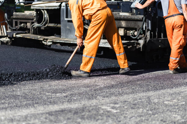 istock Workers laying asphalt on a construction road during daylight hours in an urban area 2177316487