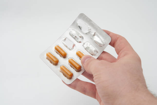 istock A hand holding a blister pack of orange pills 2177318029