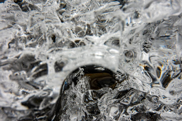 A full frame close up of the surface ice from a melting glacier that makes a good black and white abstract background