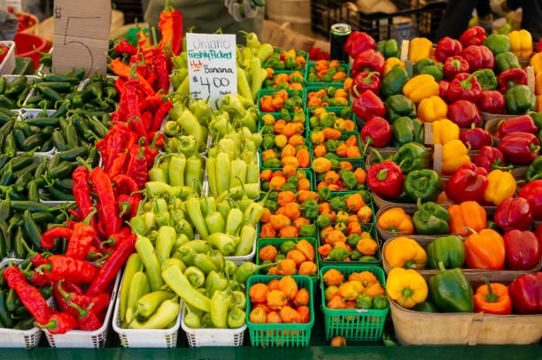istock Red, yellow, and green peppers on display at a market. 2177321047