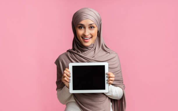 istock Arabic woman in hijab holding digital tablet with black screen 2177321871