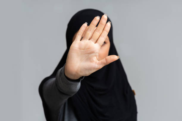 istock Muslim woman in hijab making stop gesture with her hand 2177322169