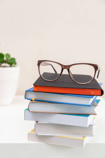 istock Glasses on a stack of books on light background. Education. learning and back to school concept. 2177325218