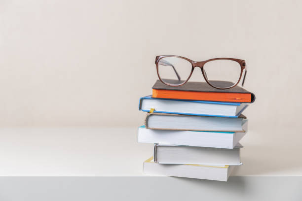 istock Glasses on a stack of books on light background. Education. learning and back to school concept. 2177325232