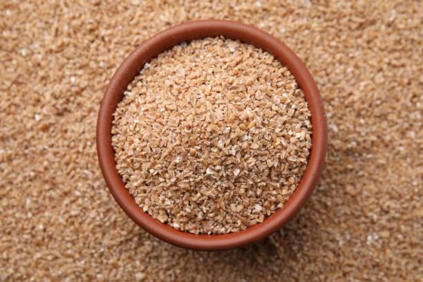 istock Bowl and dry wheat groats, top view 2177325266