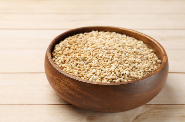 istock Dry pearl barley in bowl on light wooden table 2177325284
