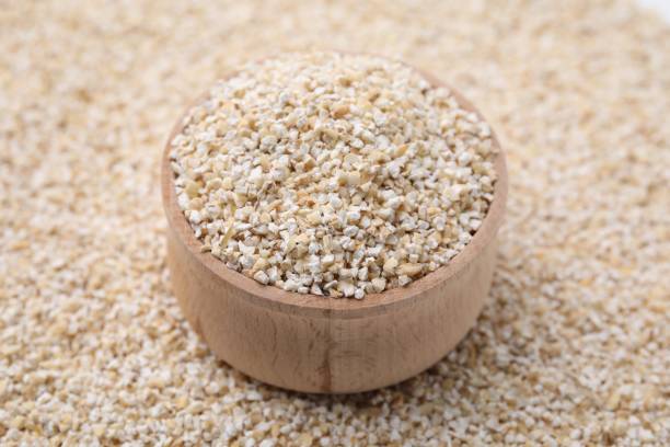 istock Wooden bowl on raw barley groats, closeup 2177325314