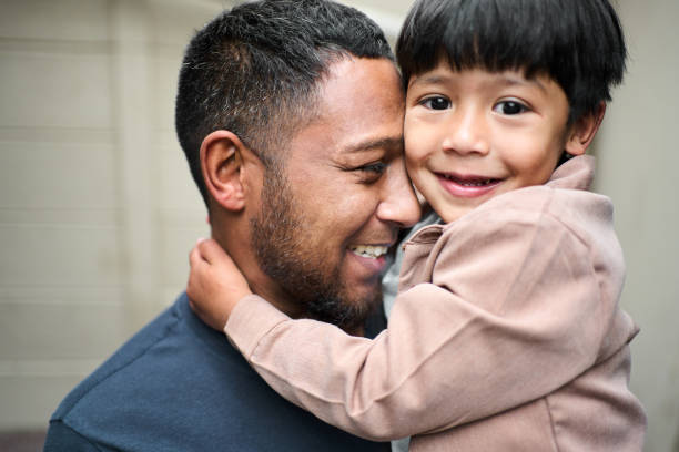 istock Little Muslim boy smiling while being held in his father's arms 2177325477