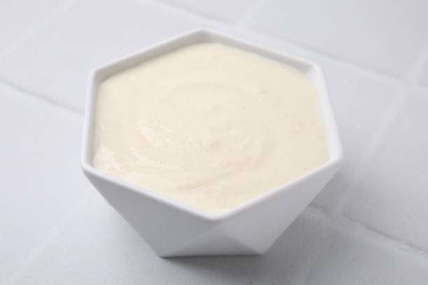 istock Bowl of delicious semolina pudding on white table, closeup 2177326207