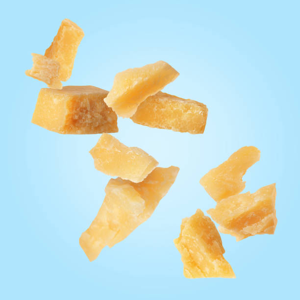 istock Tasty parmesan cheese falling on light blue background 2177326562