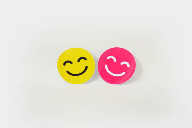 istock pink and yellow smiling emoticon card on white background with copy space 2177328534