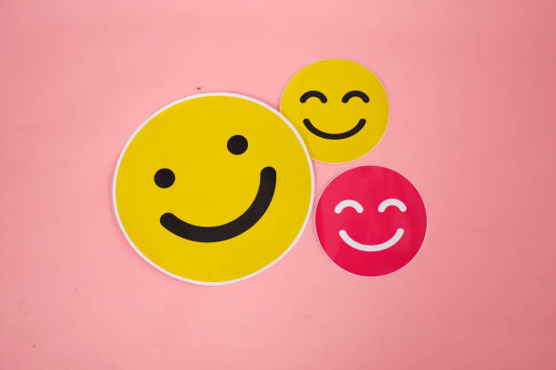 istock Yellow and pink smile emoticon sticker on pink background 2177328770