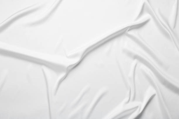 istock Texture of white crumpled silk fabric as background, top view 2177329098