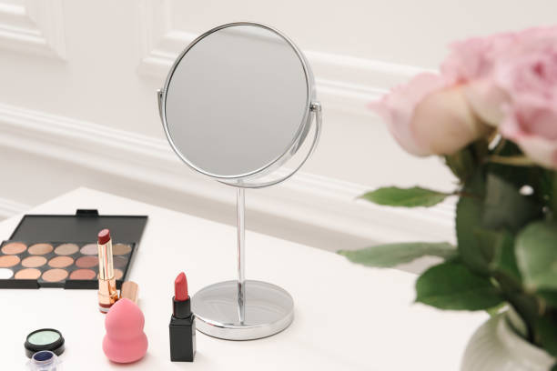 istock Mirror, cosmetic products and pink roses on white dressing table, closeup 2177329103