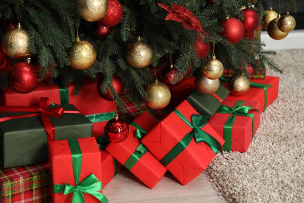 istock Many gift boxes under decorated Christmas tree in room 2177330226