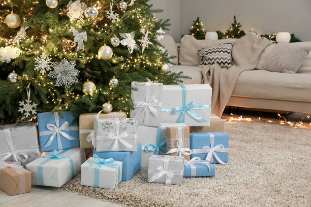 istock Many gift boxes under decorated Christmas tree in room 2177330239