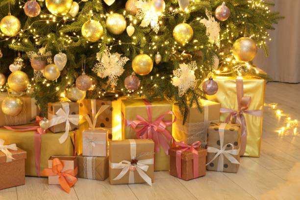 istock Many gift boxes under decorated Christmas tree at home 2177330242