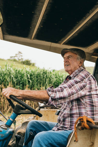Farmer driving a tractor at harvest