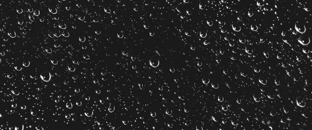 istock Atmospheric minimal grayscale backdrop with rain droplets on glass. Wet window with rainy drops and dirt spots closeup. Blurry minimalist monochrome background of dirty window glass with raindrops. 2177332991