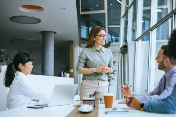 istock Joyful team leader standing in a collaborative meeting 2177333151