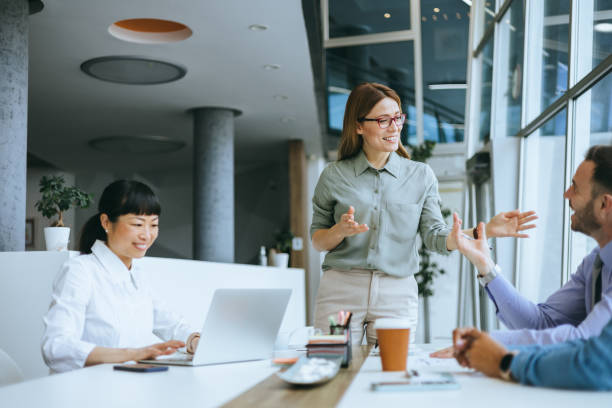 istock Smiling team leader engaging with colleagues 2177333153