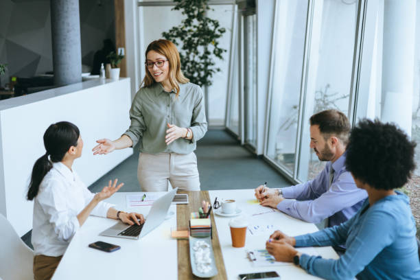 istock Confident woman leading office meeting 2177333162