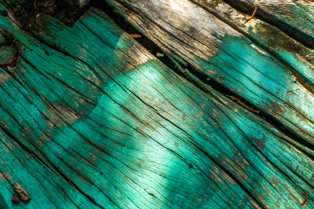 Texture of Weathered paint surface on old wood plank showing its aging and cracked surface
