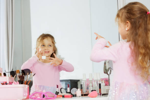istock Girl paints nails surrounded by makeup brushes and cosmetics 2177333551