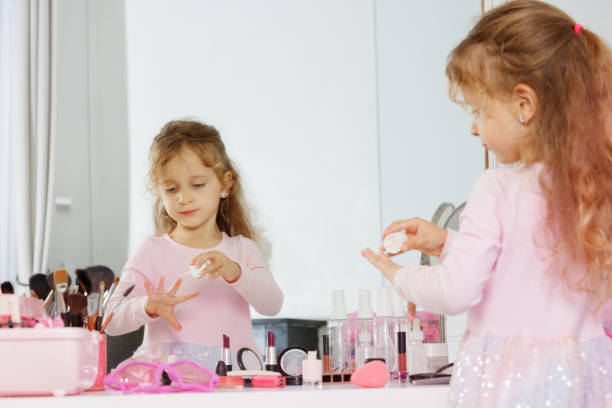 istock Girl paints nails surrounded by makeup brushes and cosmetics 2177333556