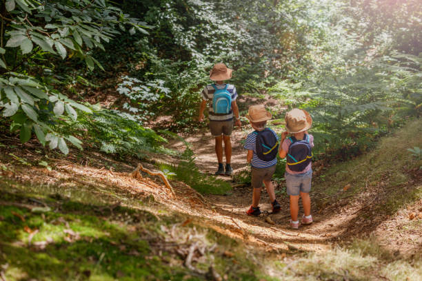 istock Children hike up wooded trail, exploring nature enthusiastically 2177333771