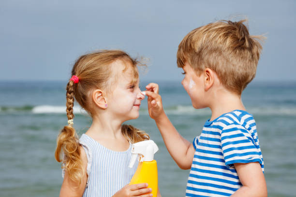 istock Kids applying sunscreen at the beach, enjoying sunny summer day 2177334004