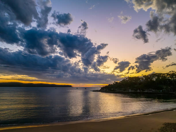 istock Sunrise over the ocean with clouds and a calm sea 2177336753