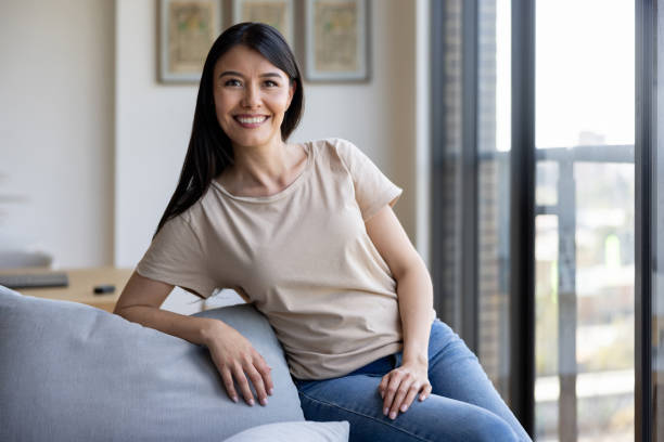 istock Happy woman at home sitting on the sofa 2177341281