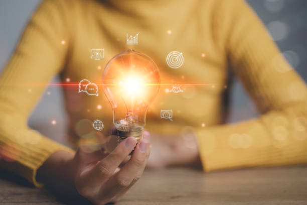 istock Hand-holding illuminated light bulb, concept creativity with bulbs that shine glitter. Inspiration of ideas for sustainable business development. Idea innovation and inspiration concept. 2177341489