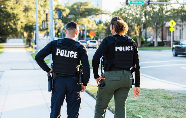istock Two police officers patrolling community on foot 2177343934