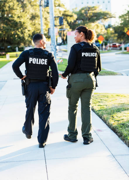 istock Two police officers patrolling community on foot 2177343935