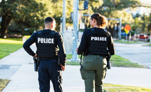 istock Two police officers patrolling community on foot 2177343937