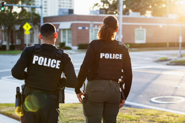 istock Two police officers patrolling community on foot 2177343938