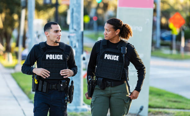 istock Two police officers patrolling community on foot 2177343939