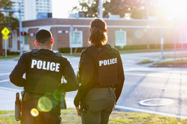 istock Two police officers patrolling community on foot 2177343940