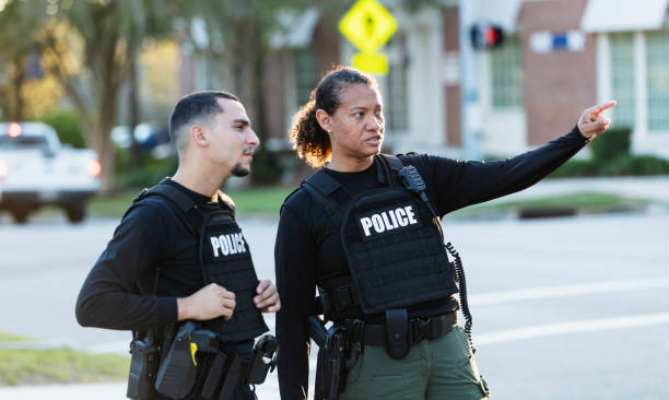 istock Two police officers patrolling community on foot 2177343941