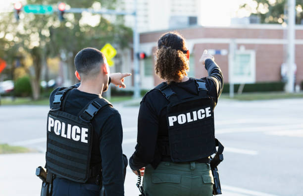 istock Two police officers patrolling community on foot 2177343945