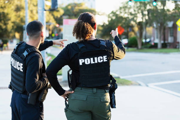 istock Two police officers patrolling community on foot 2177343946