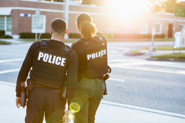 istock Two police officers patrolling community on foot 2177343948