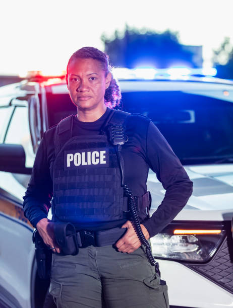 istock Multiracial policewoman standing with patrol car 2177343954