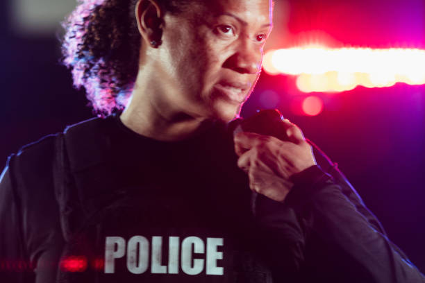istock Multiracial policewoman talking on radio at night 2177343970