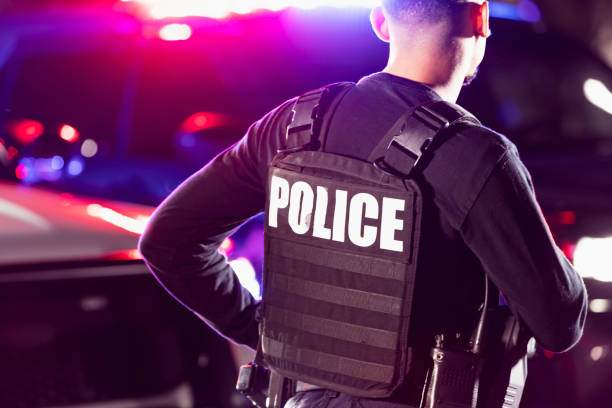 istock Hispanic police officer working at night 2177343980