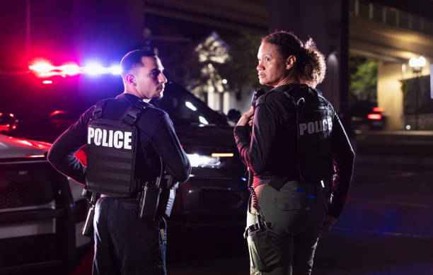 istock Two multiracial police officers working outdoors at night 2177343982