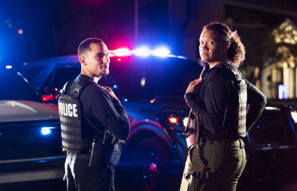 istock Two multiracial police officers working outdoors at night 2177343983