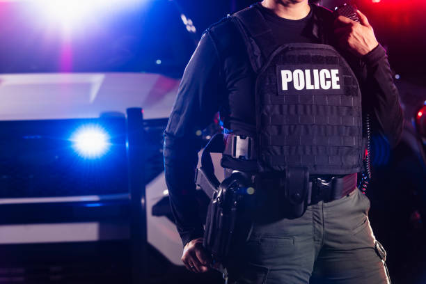 istock Multiracial policewoman talking on radio at night 2177343984